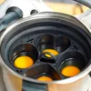 A close-up view of a cooking insert with eggs in it, placed inside a pot. Produktbild-Vorschau