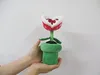 Hands holding a plush toy Piranha Plant from the Super Mario franchise. Anteprima dell’immagine prodotto