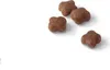 Four pieces of brown kibble on a white background. Produktbild-Vorschau