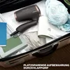 A hairdryer and other items packed into a suitcase. Anteprima dell’immagine prodotto