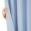 A hand is pulling back a light blue curtain. Produktbild-Vorschau