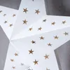 A close-up view of a white star-shaped lantern with gold star cutouts. Produktbild-Vorschau