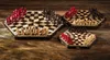 Three hexagonal chess boards with chess pieces arranged for play, set on a wooden surface. Anteprima dell’immagine prodotto