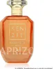 A perfume bottle with an orange hue and gold accents, set against a white background. Náhled obrázku produktu