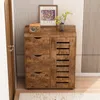 A wooden cabinet with drawers and a slatted door, decorated with a framed picture and a vase of flowers. Podgląd zdjęcia produktu