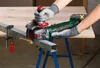 A person wearing gloves is using a cordless angle grinder to cut a metal beam. Sparks are flying from the cut. Produktbild-Vorschau