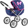 A doll stroller with a navy blue fabric patterned with pink triangles and a pink bow on the hood. Produktbild-Vorschau