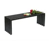 A black metal bench with a bouquet of red roses and a small book on top, isolated on a white background. Produktbild-Vorschau