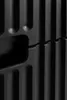 A close-up, abstract view of a black ribbed surface, possibly a piece of furniture or electronic equipment. Náhľad obrázku produktu