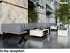 A modern reception area with a sectional sofa and marble coffee tables. Produktbild-Vorschau