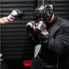 Two people sparring with boxing gloves and headgear. Voir les images du produit