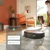 A robot vacuum cleaner is shown on a rug in a living room, with a dog and a person nearby. A smartphone screen displaying app information is overlaid on the image. Náhled obrázku produktu