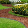 A garden path with lawn edging separating grass from flower beds. Náhled obrázku produktu