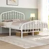A white metal bed frame with a headboard and footboard is shown in a bedroom setting. Produktbild-Vorschau