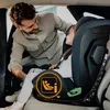 A man is putting a child into a car seat in the back seat of a car. Produktbild-Vorschau