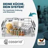 A kitchen drawer organizer with various jars of food items and a folded cloth. Produktbild-Vorschau