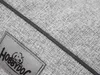 A close-up view of a gray fabric product with a label. Náhľad obrázku produktu