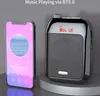 A portable speaker and a smartphone are displayed side-by-side on a gray surface. The smartphone screen shows a music player interface with a pink gradient background and a circular image of a seascape. The speaker is black and silver with a mesh front and Produktbild-Vorschau