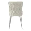 A back view of a single beige upholstered dining chair with tufted detailing and silver metal legs, isolated on a white background. Produktbild-Vorschau