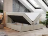 A beige upholstered bed with its storage compartment open, revealing the mattress and internal storage space. The bed is set in a room with slanted ceilings and skylights, suggesting a modern attic or loft setting. Produktbild-Vorschau