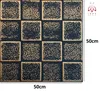 A close-up view of wall panels with a checkered pattern of black and gold squares. Produktbild-Vorschau