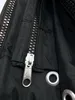 A close-up view of a black PVC fabric with a zipper and metal grommets. Produktbild-Vorschau