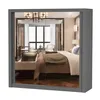A mirrored wardrobe reflecting a bedroom scene. Voir les images du produit