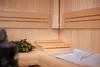 Interior of a wooden sauna with benches and a bundle of birch branches. Produktbild-Vorschau