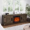 A media console with an electric fireplace is shown in a living room setting, placed against a window with sheer curtains. Produktbild-Vorschau