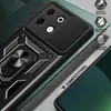 A close-up view of a black phone case with a ring stand and camera cover, placed on a textured surface with green accents. Produktbild-Vorschau