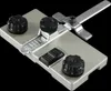 A close-up studio shot of a metal guide rail adapter with black knobs and markings. Produktbild-Vorschau