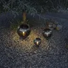 Three decorative spherical lights are placed on a gravel path next to a tree at night. Produktbild-Vorschau