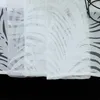 A close-up view of a white sheer curtain with a leaf pattern. Produktbild-Vorschau