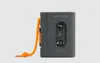 A gray portable cassette player with an orange cord attached, set against a light gray background. Voir les images du produit