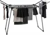 A drying rack with clothes hanging on it. Produktbild-Vorschau