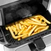Close-up shot of french fries cooking in an air fryer. Podgląd zdjęcia produktu