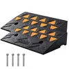 Two black rubber ramps with orange triangular textured inserts, shown diagonally with four metal bolts in the foreground. Produktbild-Vorschau
