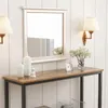 A console table with decorative items in a room with paneled walls. Produktbild-Vorschau