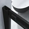 A close-up view of a black shower enclosure frame next to a modern black and white bathtub. Produktbild-Vorschau