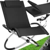 A black lounge chair with a silver frame is shown on a green grassy surface with some water droplets on a textured overlay in the bottom right corner. Náhled obrázku produktu