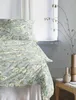 A bed with floral patterned bedding is shown next to a window with a vase of branches. Produktbild-Vorschau