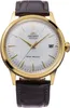 A close-up studio shot of a gold-toned watch with a white face and a brown leather strap. Produktbild-Vorschau