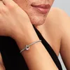 A close-up shot of a person's arm wearing a silver Pandora charm bracelet with a heart-shaped charm. Anteprima dell’immagine prodotto