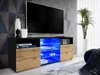 A modern TV stand with a black matte body, wotan matte front, and illuminated blue shelves, displaying a TV and decorative items. Náhled obrázku produktu