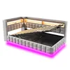 A light gray upholstered bed frame with a slatted mattress base lifted to reveal storage space underneath. The headboard has integrated LED lighting, and there is also pink LED lighting along the base of the bed frame. Anteprima dell’immagine prodotto