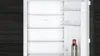 An empty refrigerator with a single bottle on the bottom shelf. Produktbild-Vorschau