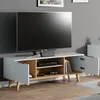 A modern TV stand with a television on top, in a living room setting. Náhľad obrázku produktu