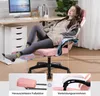 A woman relaxing in a pink gaming chair with her feet up on a footrest, next to a desk with a computer. Náhľad obrázku produktu