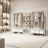 A well-organized closet with a white open wardrobe rack displaying clothes and accessories. Produktbild-Vorschau