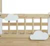 A close-up view of a wooden children's bed with cloud decorations. Anteprima dell’immagine prodotto
